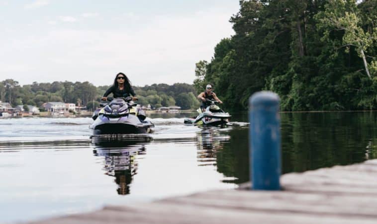 People on Sea-Doo's Pulling Up to a Dock